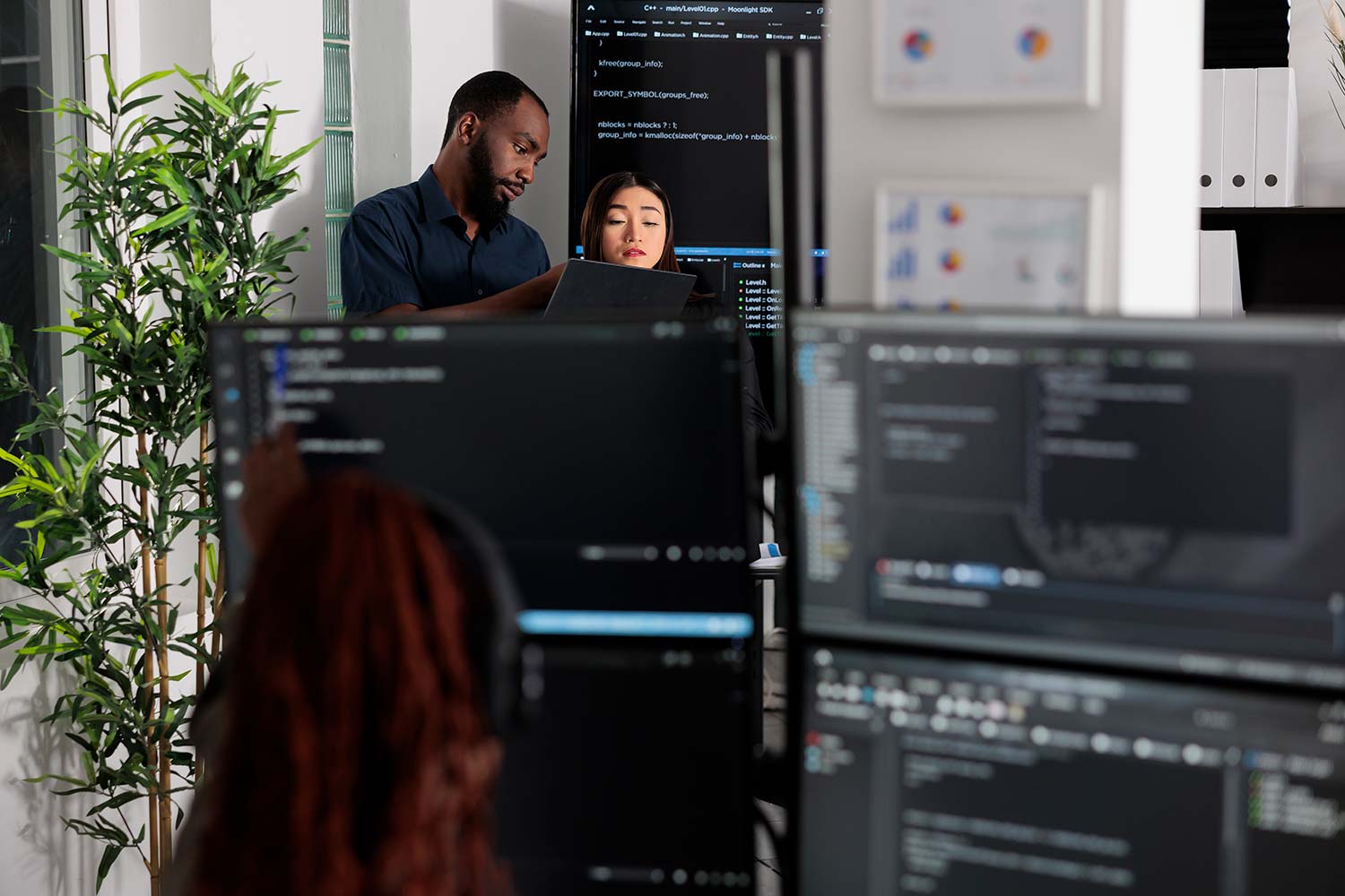App developers looking at interpreted and compiled languages on screens